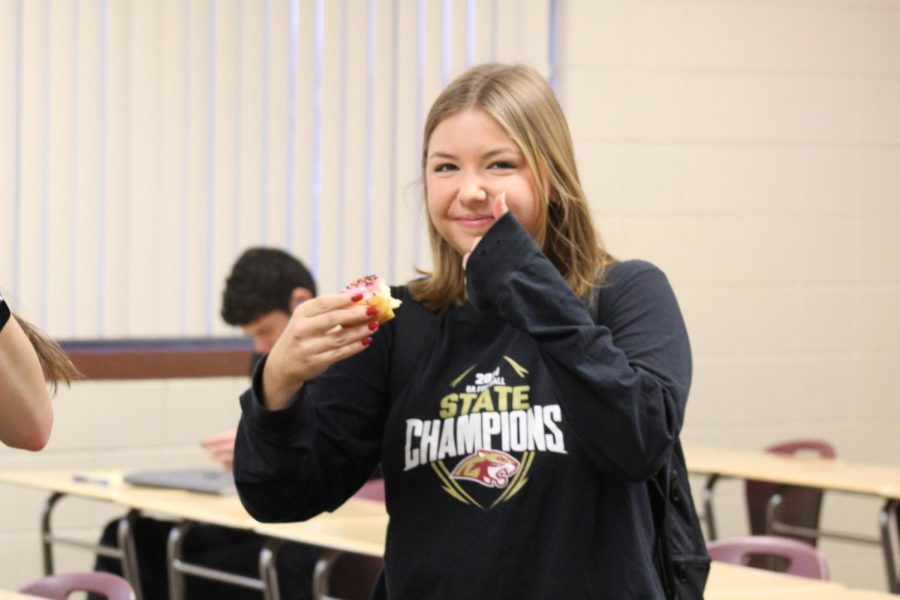 Libby Steene Enjoying a Strawberry Sprinkled Donut in A107